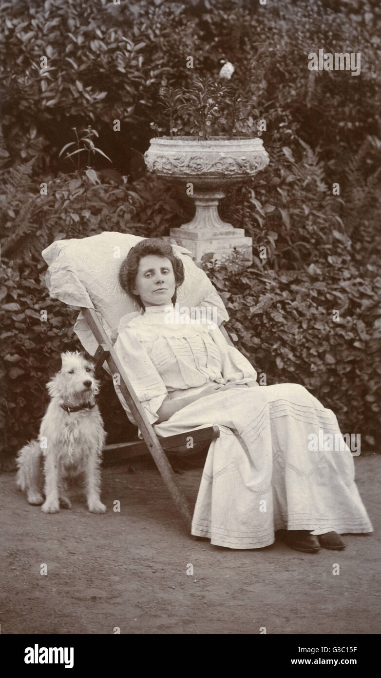 Young woman and dog in a garden Stock Photo - Alamy