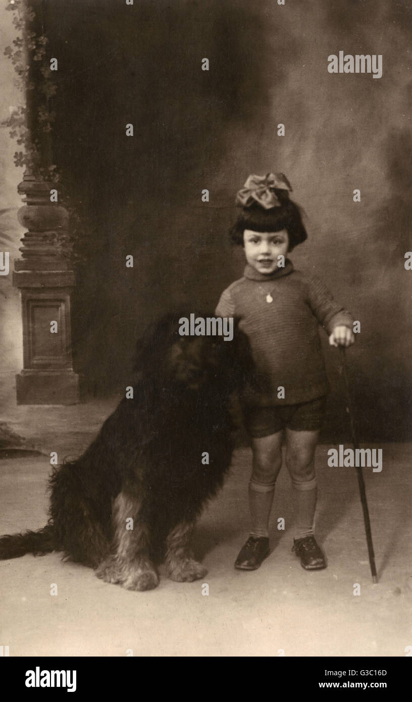 Studio portrait, little girl with large dog, France Stock Photo