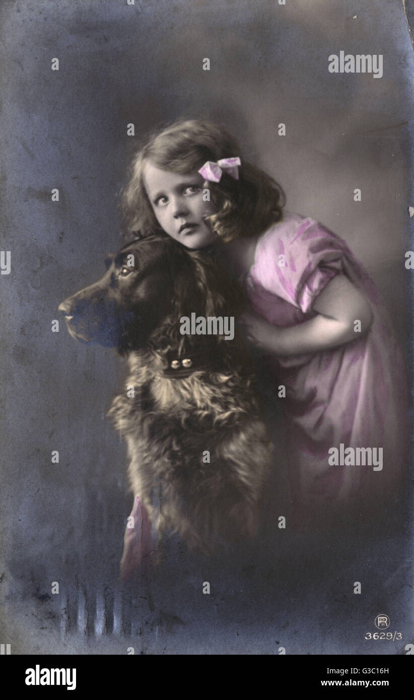 Studio portrait, little girl with large dog Stock Photo