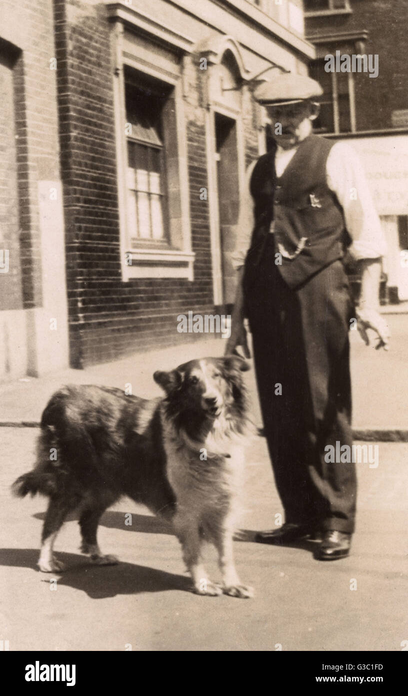 Man with a collie dog in a street Stock Photo