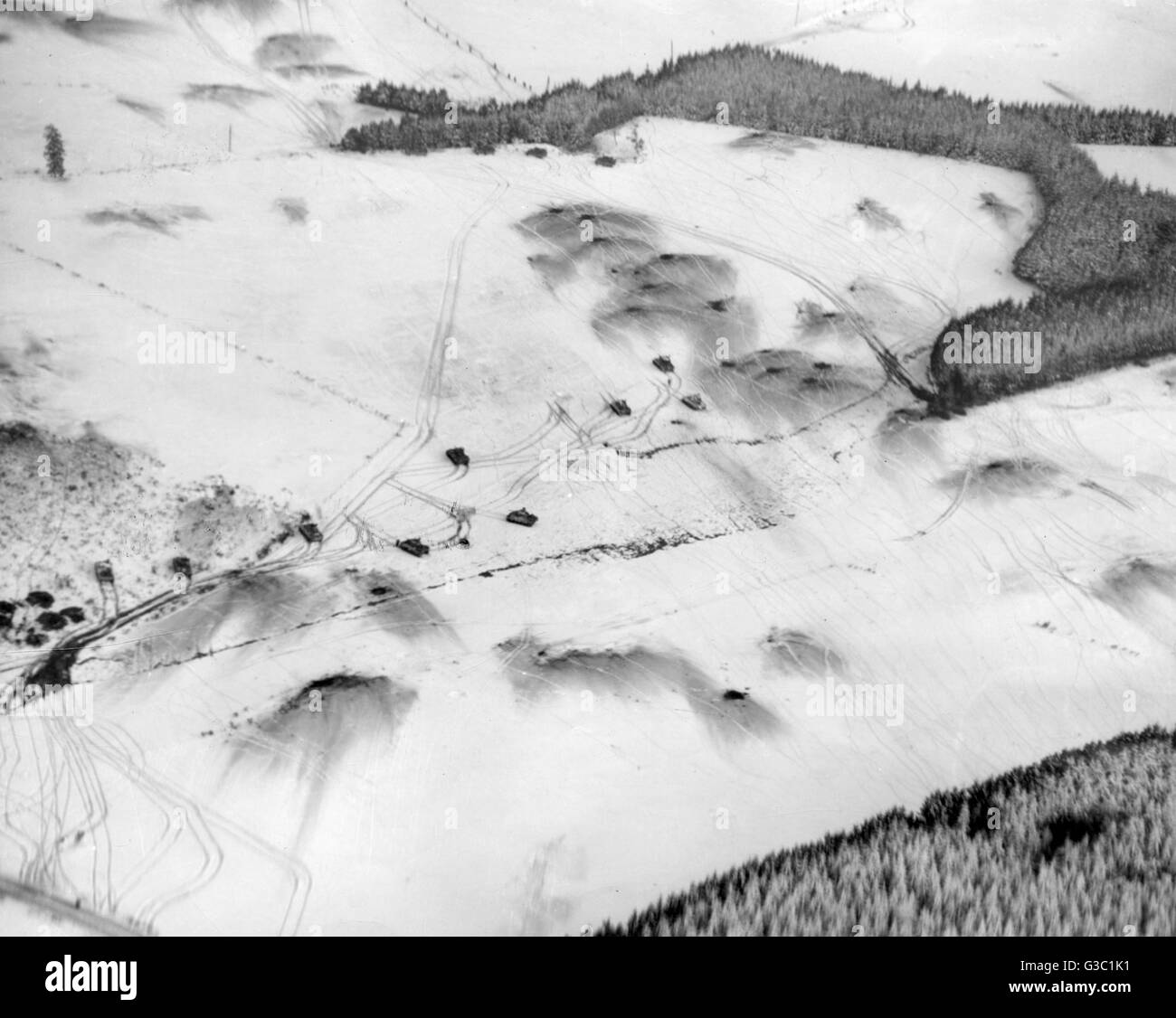 An aerial view showing tanks and infantry of the American 6th Armored Division advancing through the snow  in the direction of northeast Bastogne, during the Battle of the Bulge     Date: 13 January 1945 Stock Photo
