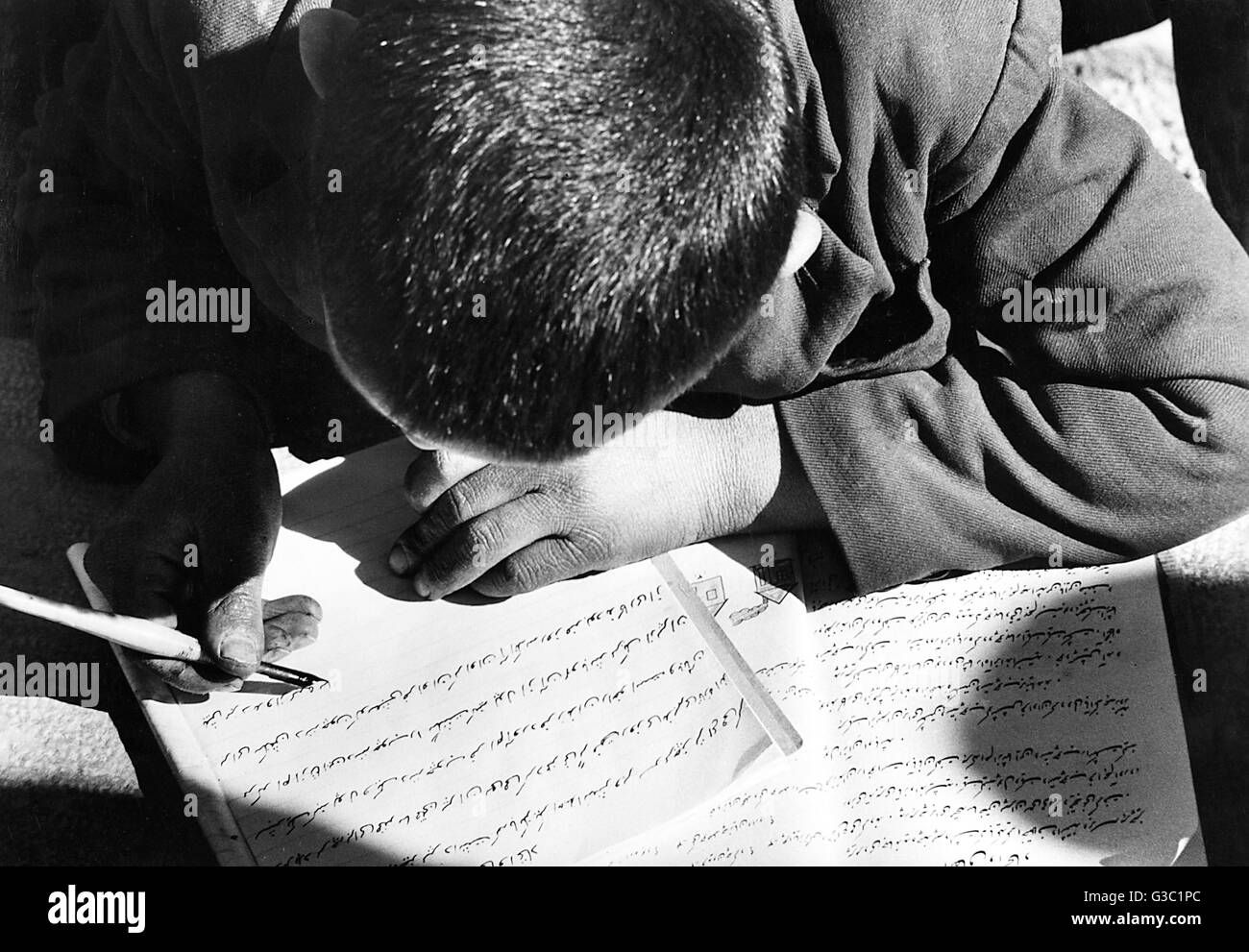 Persian schoolboy doing homework, Isfahan, Persia (Iran) Stock Photo