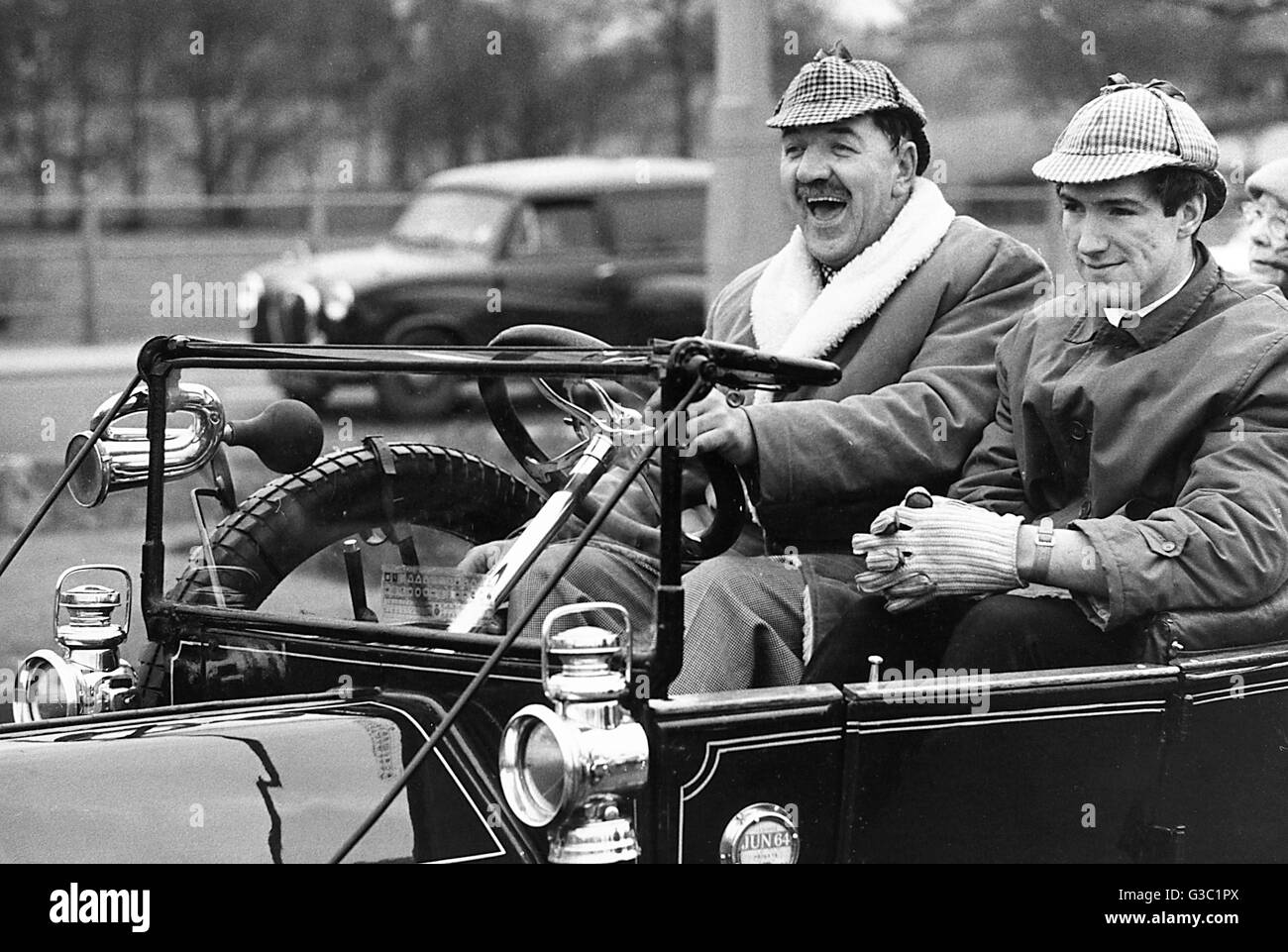 Two men having fun in a vintage car-- possibly taking part in the annual London to Brighton run.      Date: circa 1964 Stock Photo