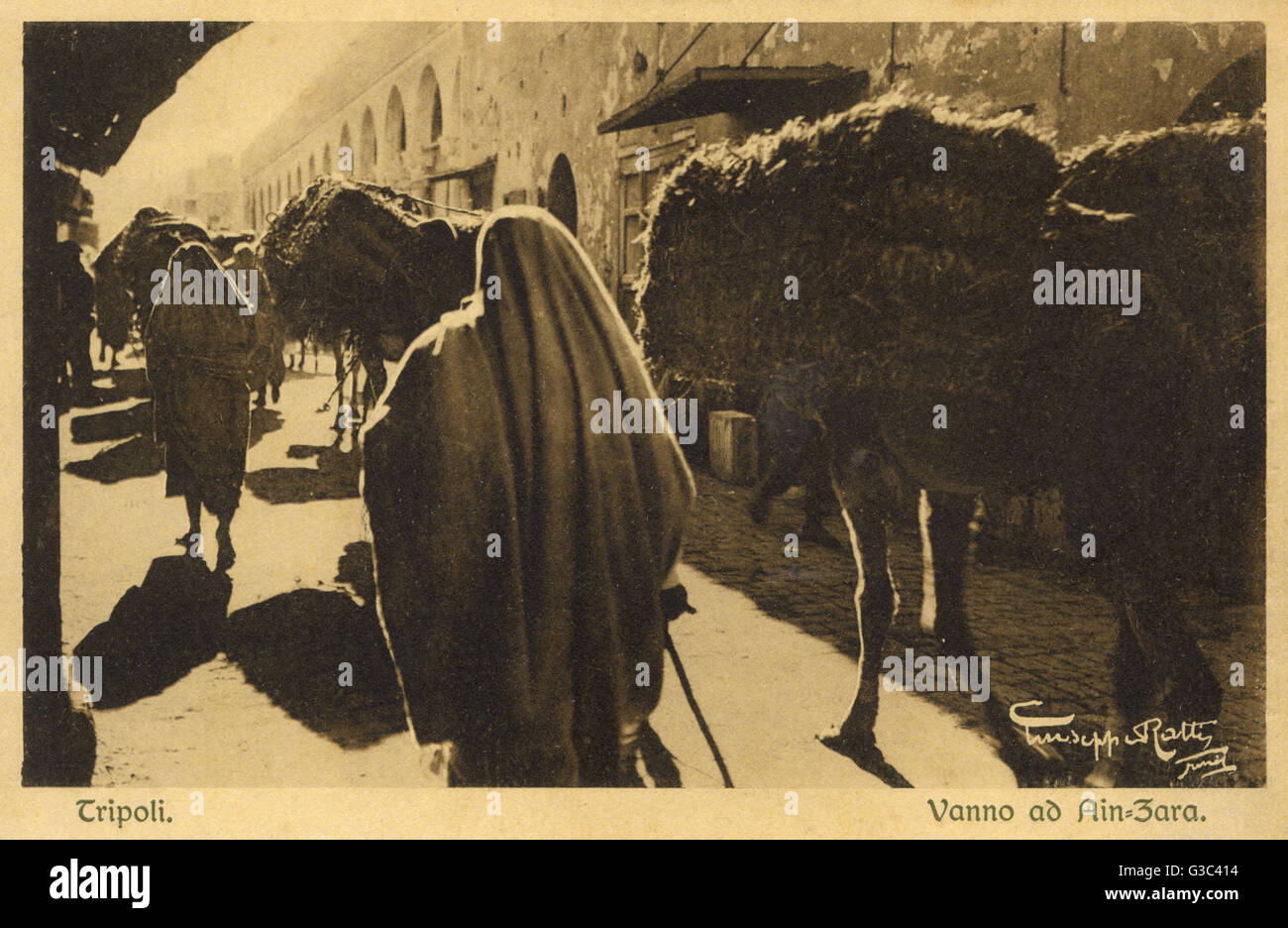 Street scene in Ain Zara, Tripoli, Libya, with people and camels. Date:  circa 1920 Stock Photo - Alamy