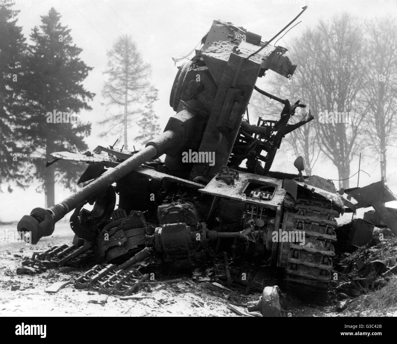 The wreckage of a German tank, destroyed near Bastogne during the Battle of the Bulge in the Ardennes area of Belgium     Date: 1944-45 Stock Photo