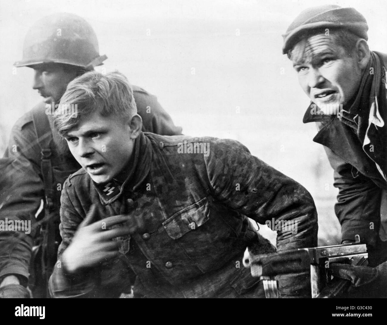 Soldiers of the 82nd American Airborne Division bring an S.S.Trooper back to Allied lines, captured between Malmedy and Marche during a reconnaissance patrol following the German counter-offensive that became known as the Battle of the Bulge.     Date: De Stock Photo