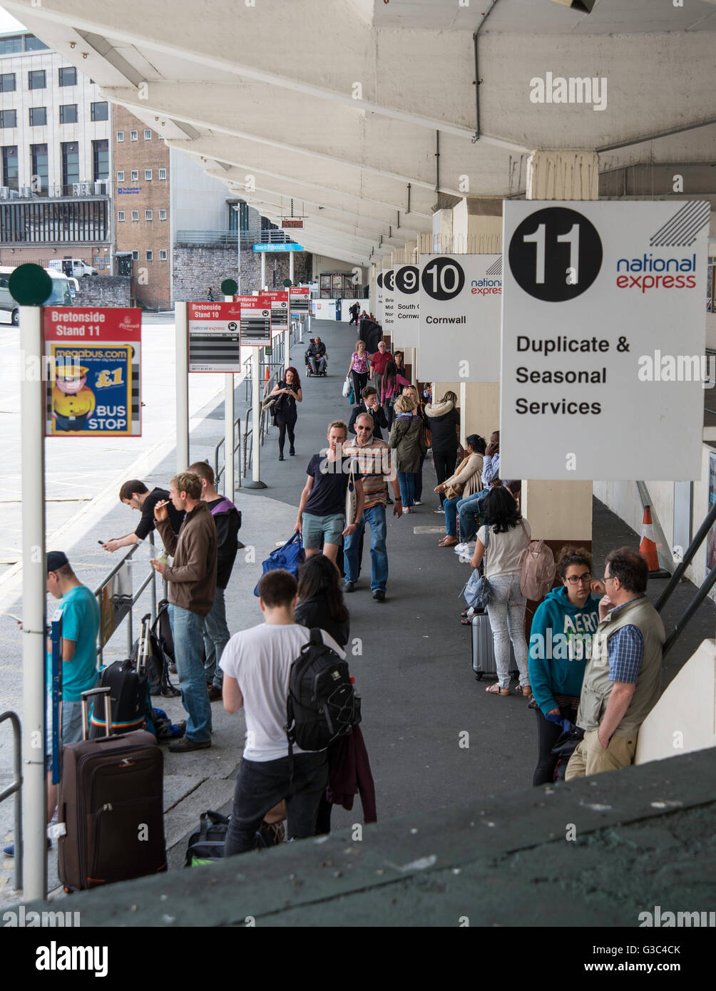 Passengers waiting for buses at Plymouth bus station Stock Photo Alamy