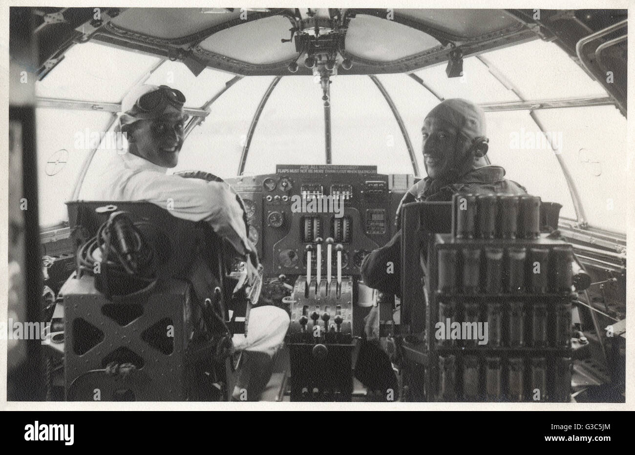 Two men at the controls of a Sunderland flying boat Stock Photo