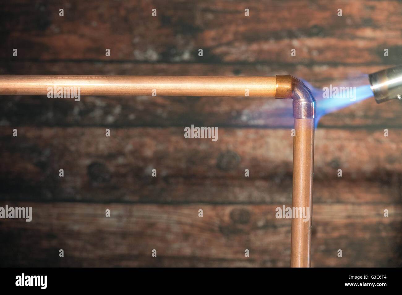 Soldering a bend onto copper tube with a blowtorch Stock Photo