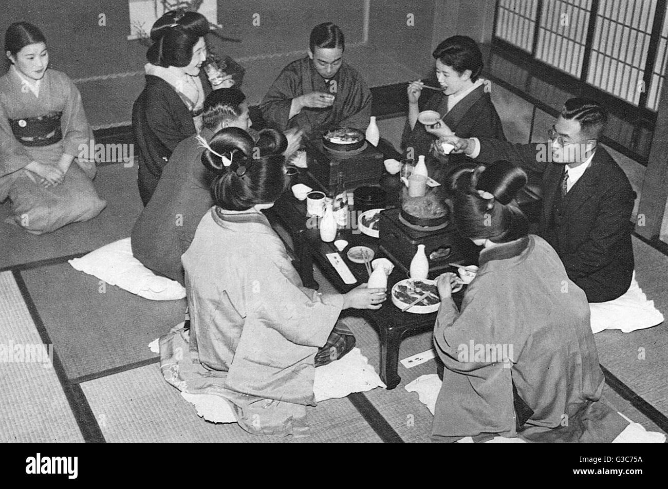 A group of Japanese people eating a meal. Stock Photo