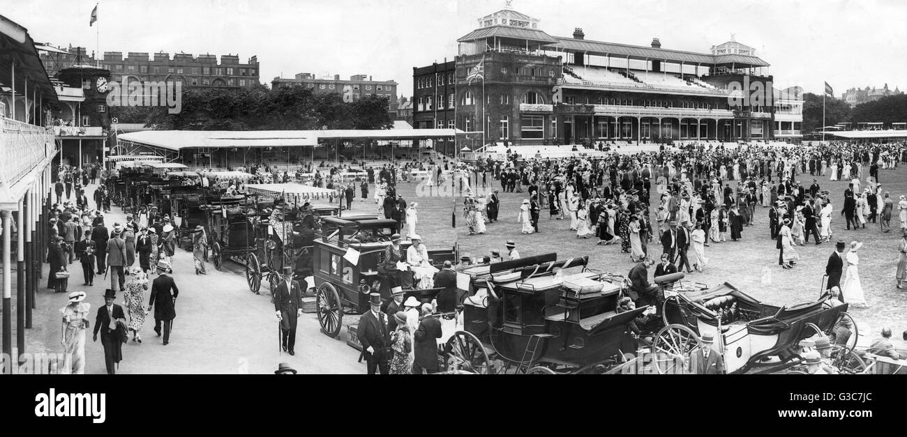 Panoramic scene during the annual Eton v Harrow cricket match at Lords Cricket Ground in NW London, 13 July 1934.  Showing a social scene during the lunch interval, with some people in traditional carriages and others strolling about.  The match itself wa Stock Photo