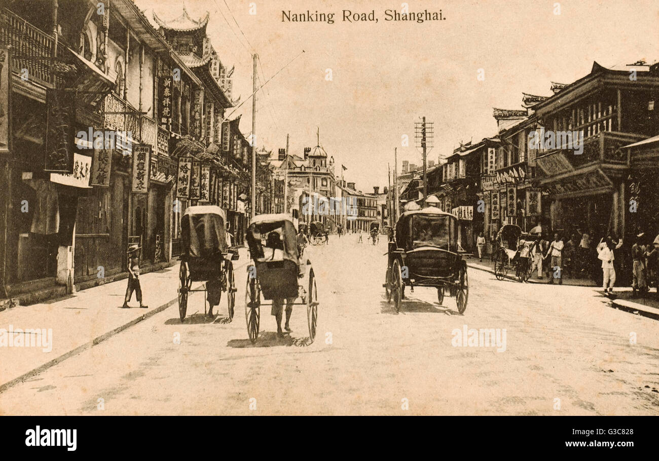 China - Shanghai - Nanjing Road - Rickshaws and shops Stock Photo