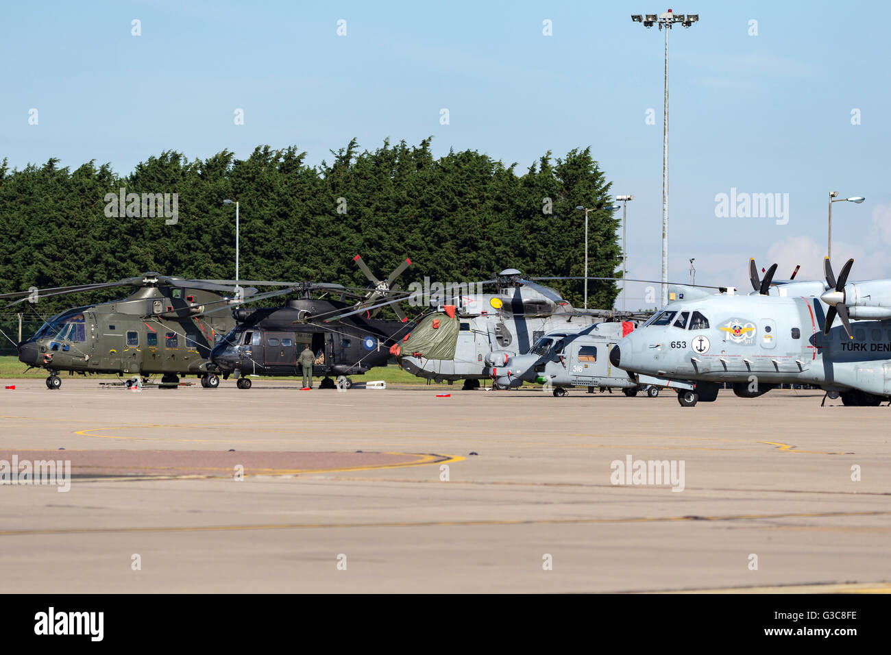 Military Helicopters lined up at RAF Waddington including RAF Merlin and Puma joined by a Royal Navy Sea King and Lynx Stock Photo