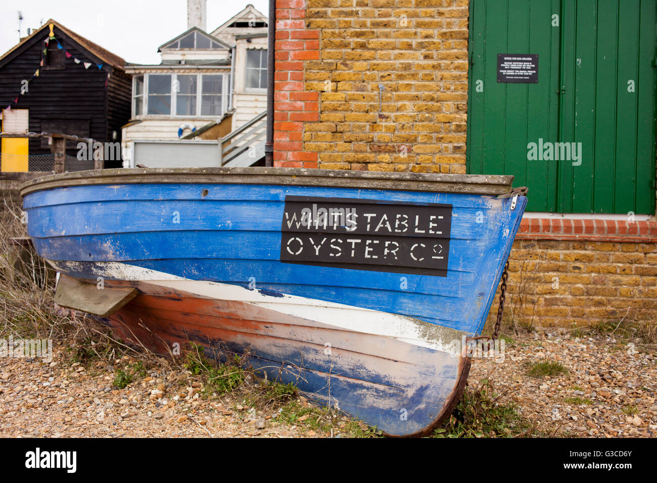 Wooden Whitstable Oyster Company boat on beach in Whitstable, Kent