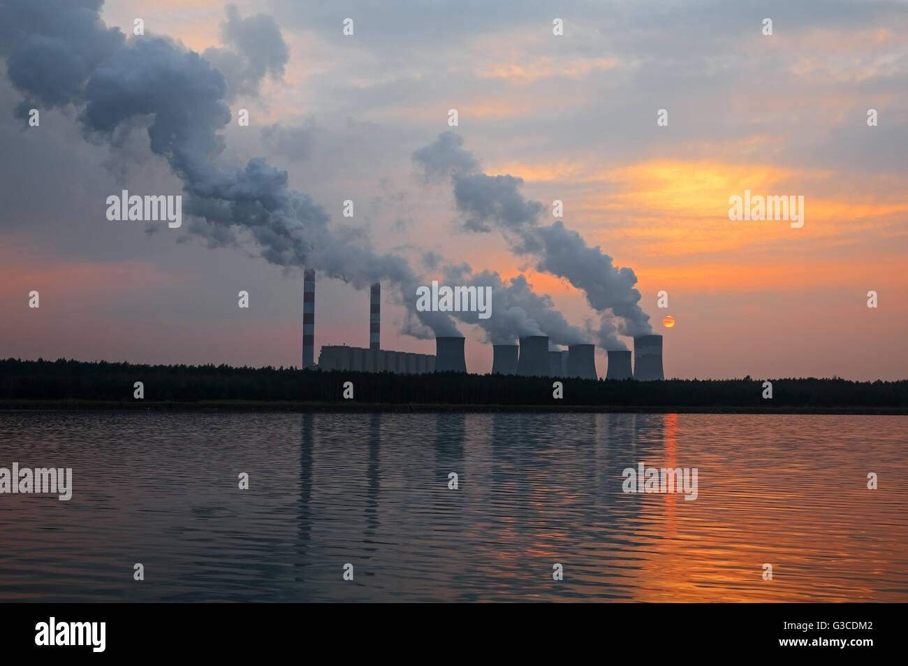 The smoke from the chimneys of a power plant at sunset Stock Photo - Alamy
