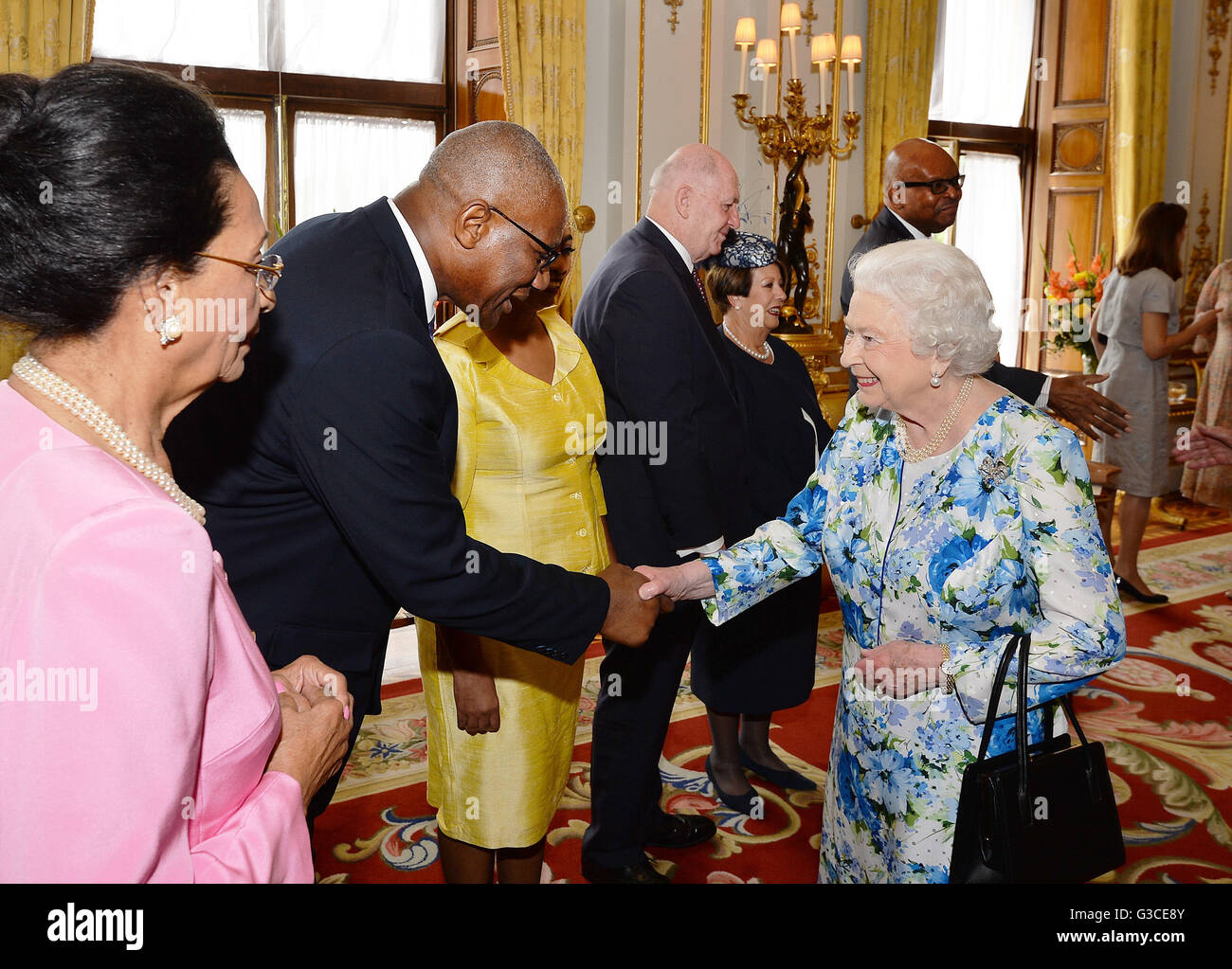 Queen Elizabeth II shakes hands with Sir Rodney Williams of Antigua and Barbuda, during a reception ahead of the Governor General's lunch at Buckingham Palace in London. Stock Photo