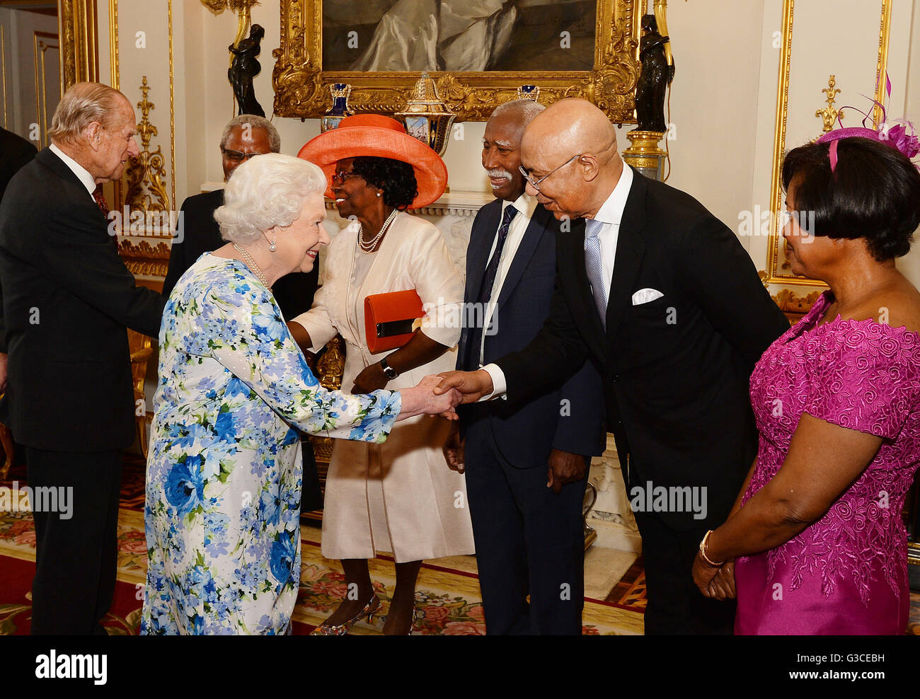 Queen Elizabeth II shakes hands with Sir Patrick Allen of Jamaica, during a reception ahead of the Governor General's lunch at Buckingham Palace in London. Stock Photo