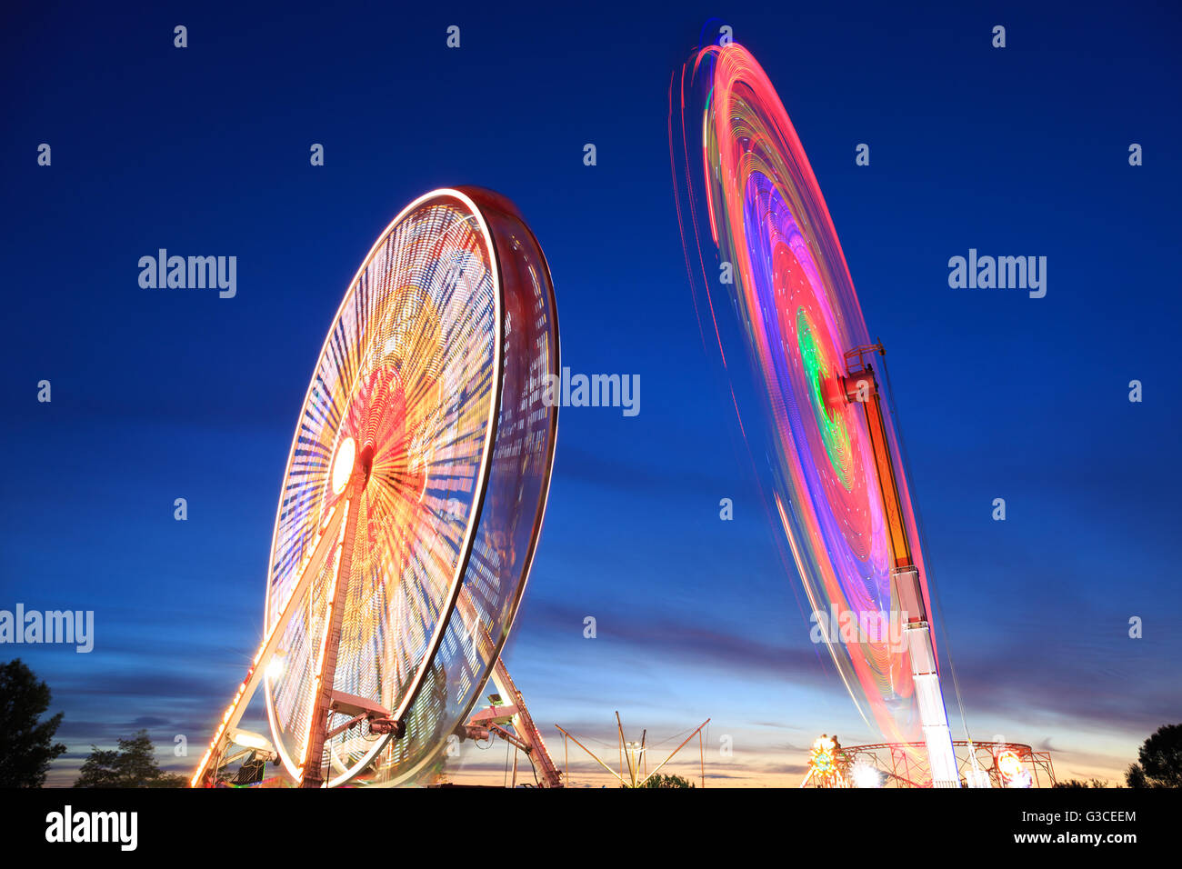 Amusement park at night - Ferris wheel in motion Stock Photo - Alamy