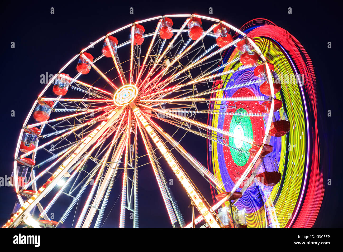 Amusement park at night - Ferris wheel in motion Stock Photo - Alamy
