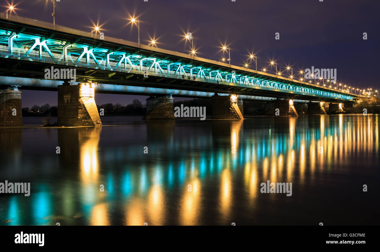 Highlighted bridge at night and reflected in the water.Bridge Gdanski Stock Photo