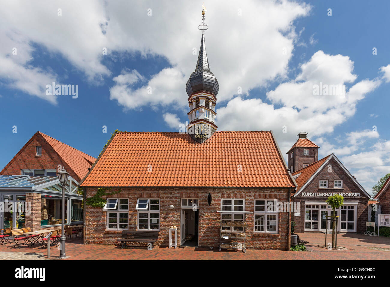 'Muschelmuseum' of Hooksiel with onion-domed tower, former 'Künstlerhaus', school, town hall, tourist information, 'Künstlerhaus' of Hooksiel on the right side, district of the municipality Wangerland, district of Friesland, Stock Photo