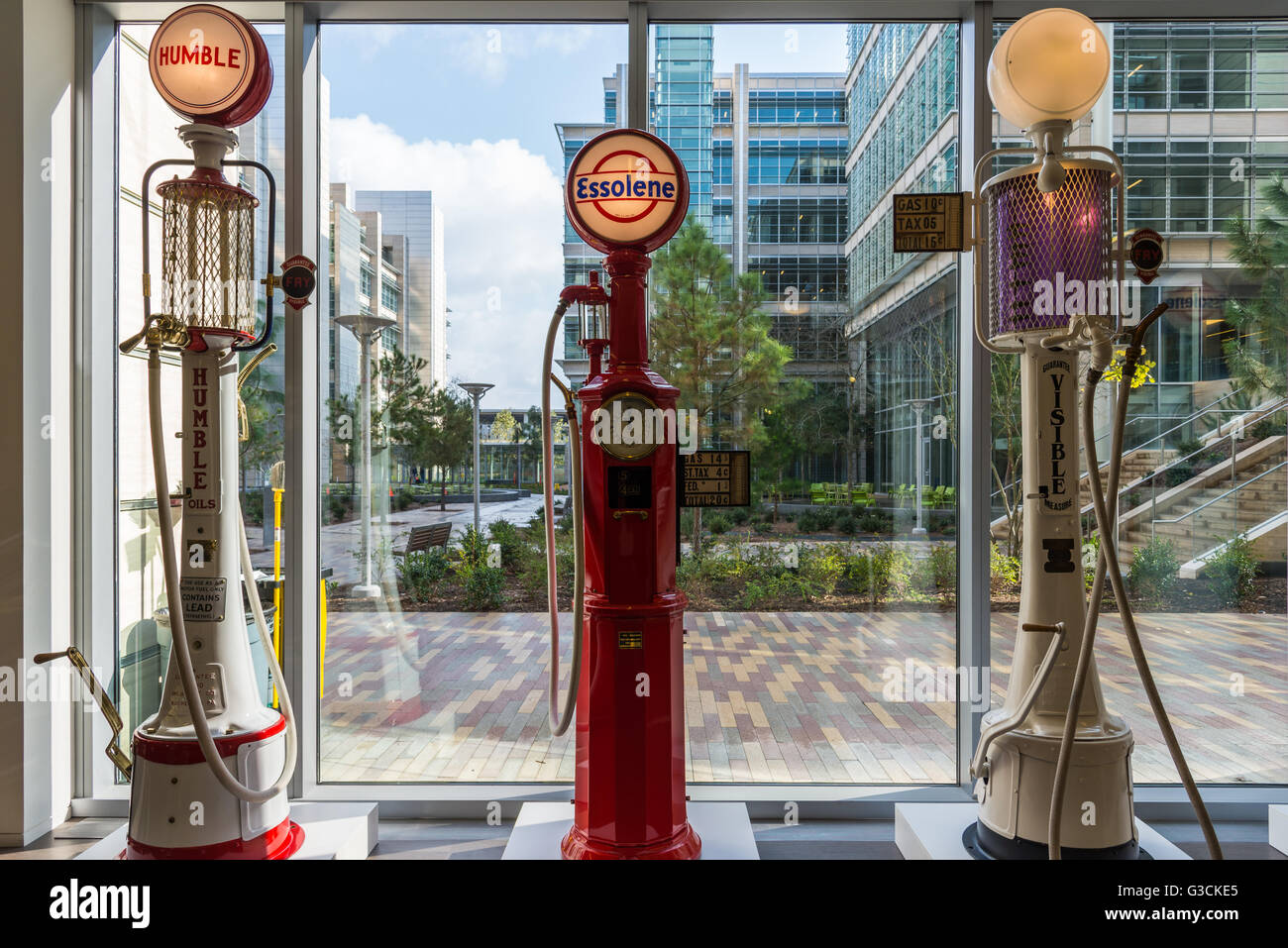 Vintage gas pumps in display by a glass window Stock Photo - Alamy