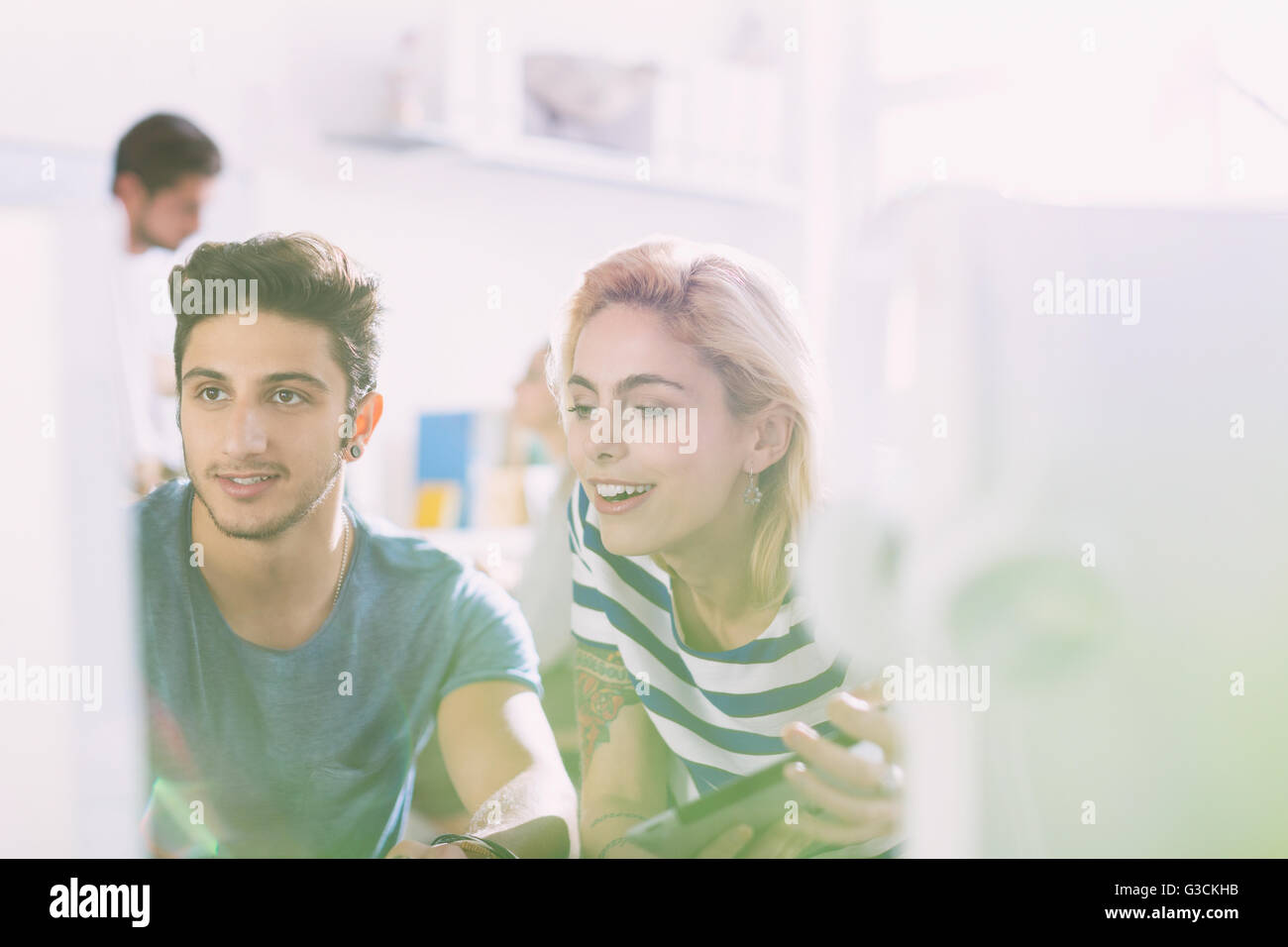 Creative young business people working at computer in office Stock Photo