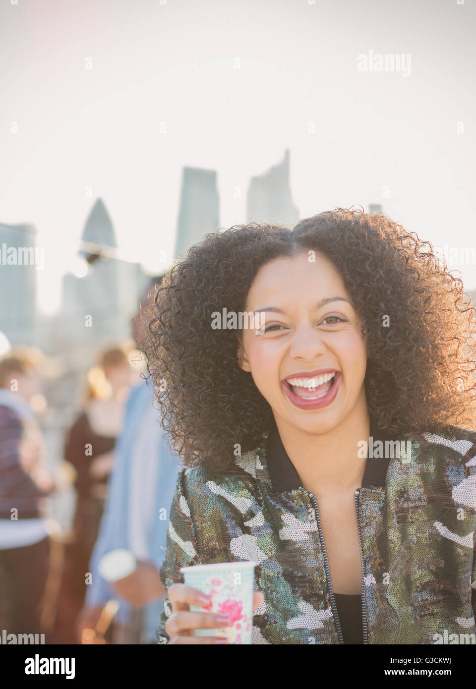 Portrait laughing young woman drinking at party Stock Photo