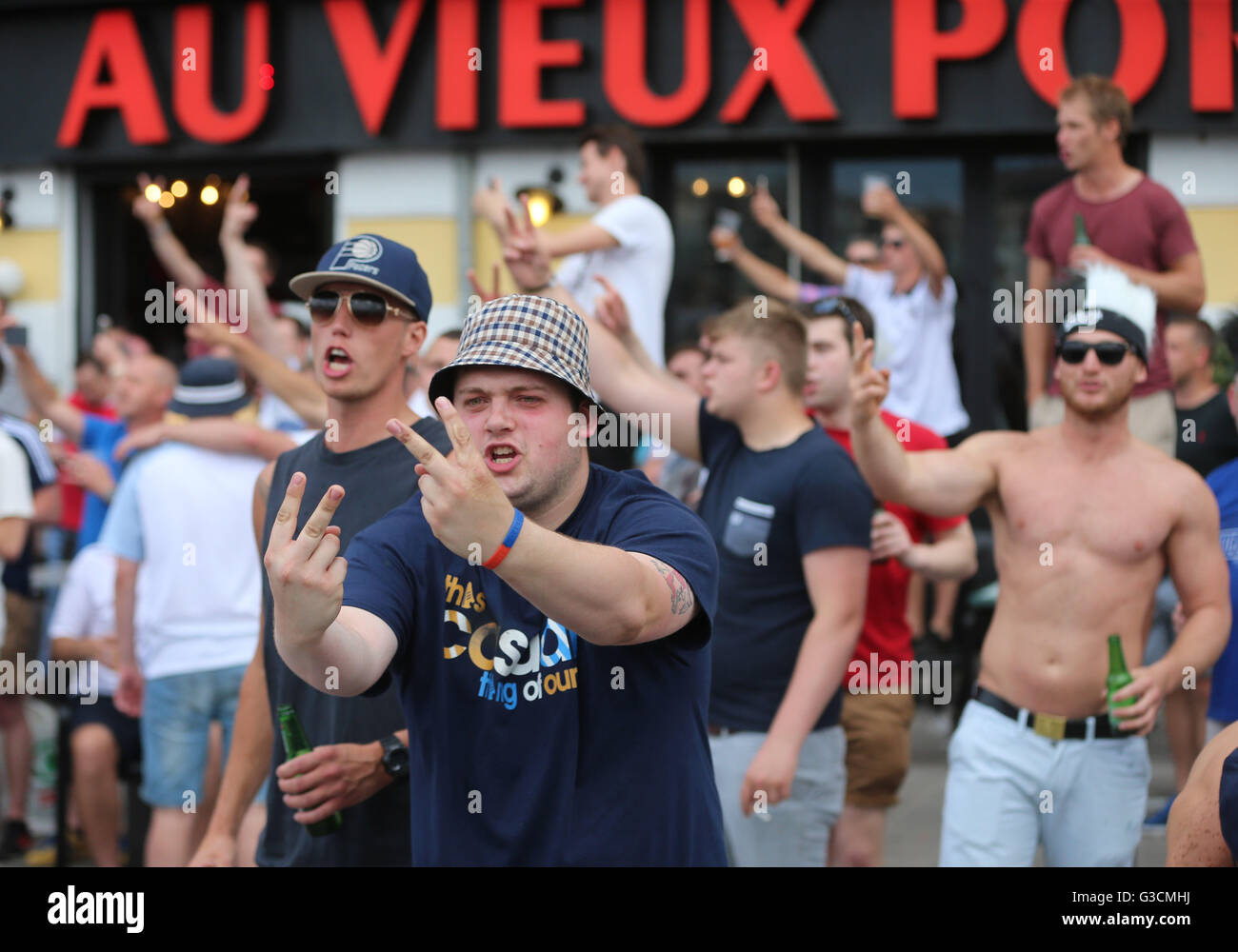 MOTE GESTURE English football fans taunt French fans in the Olde Town area in Marseille ahead of the first game in Euro 2016. Stock Photo