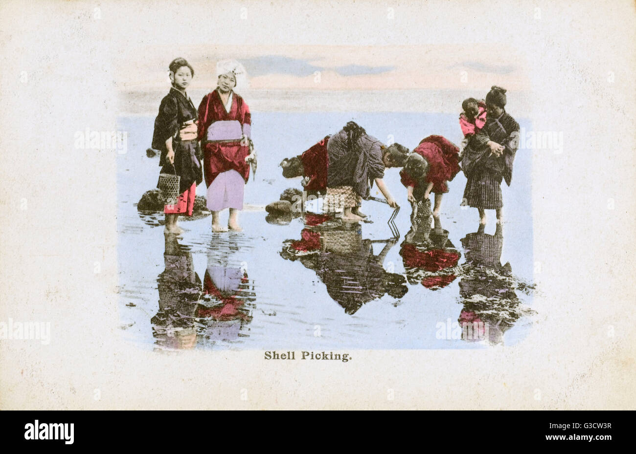 Japan Women collecting mussels on the beach at low tide Stock Photo