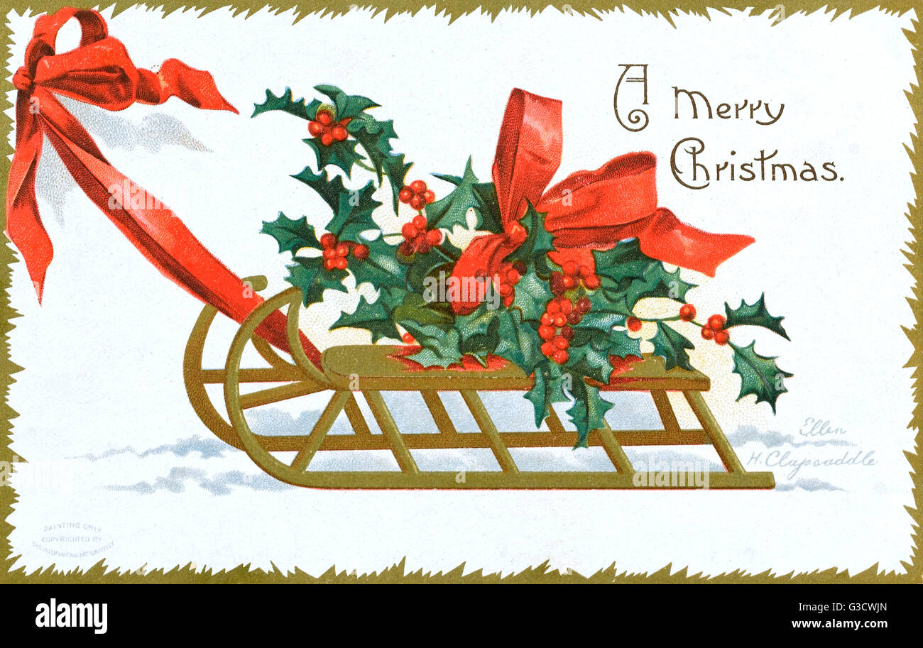 Delightful Chromolithograph Christmas greetings postcard by Ellen H. Clapsaddle depicting a large bunch of Christmas holly, tied up with a red ribbon, being pulled along atop a wooden frame sled.     Date: circa 1907 Stock Photo