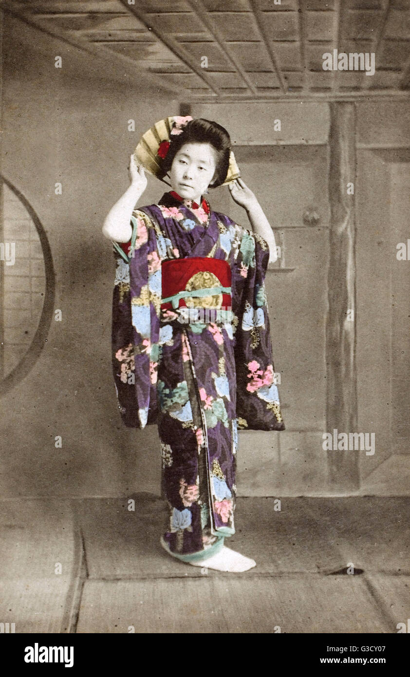 Japan Geisha Girl Studio Pose Holding Fan Behind Her
