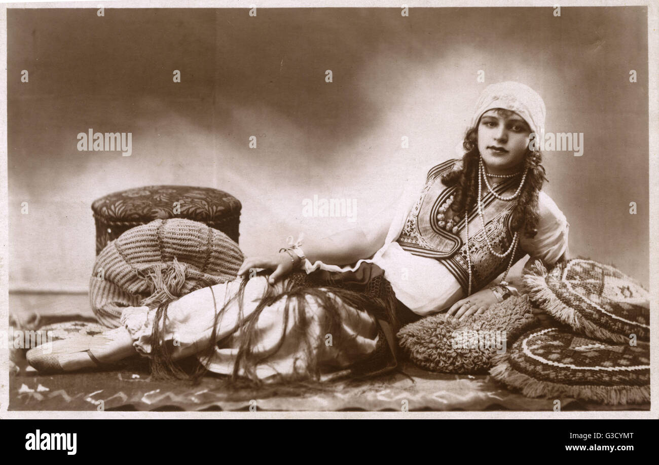 Pretty Hungarian Girl reclining amongst cushions     Date: circa 1925 Stock Photo