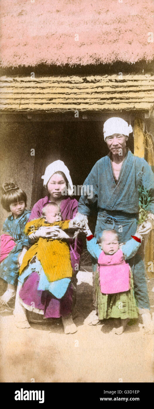 Rural Japanese peasant family outside their home Date circa 1905 Stock