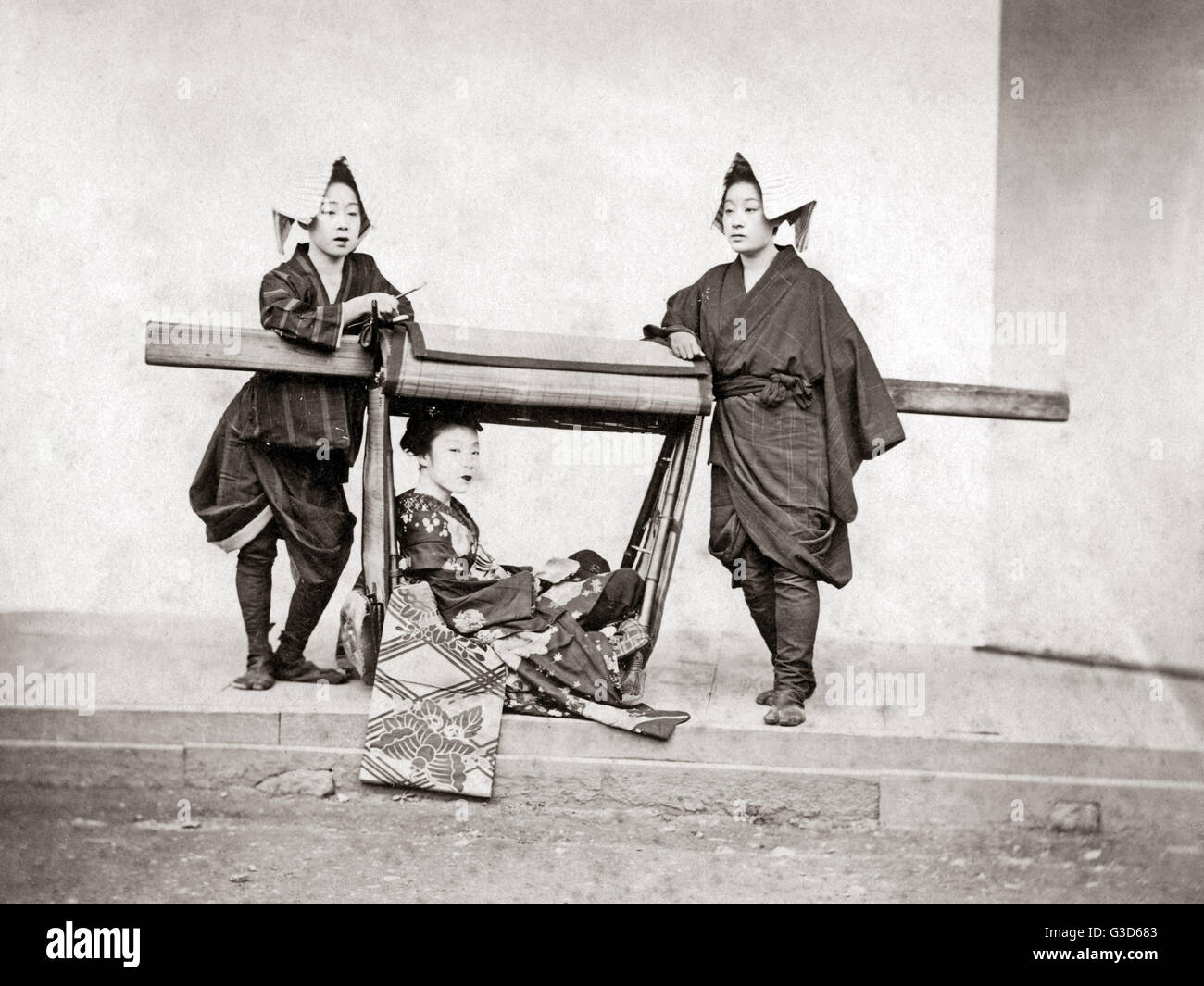 Female bearers and a carrying chair, Japan, 1870s.     Date: 1870s Stock Photo
