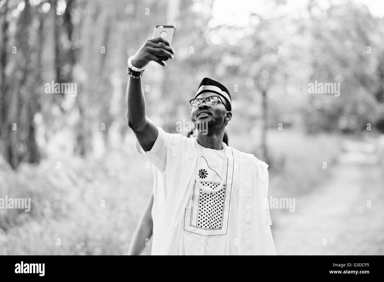 Happy cheerful black african couple in love doing selfie on they phone Stock Photo