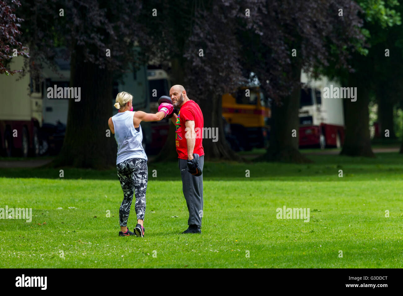 Couple sparring early morning in Abington Park, Northampton. Stock Photo