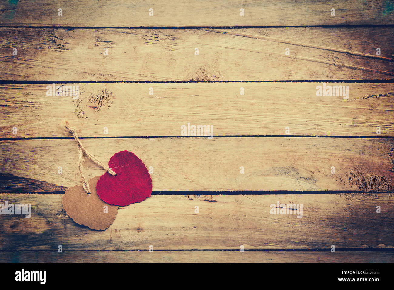 Two red and brown heart on wooden background with vintage style Stock ...