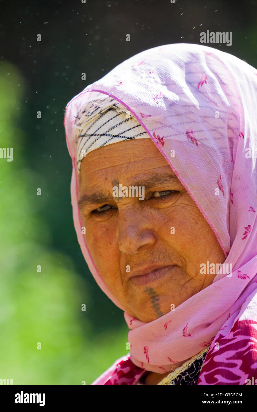 Berber woman with face tattoo at Ouzoud Falls ( Cascades d'Ouzoud ) in Atlas Mountains in Morocco Stock Photo