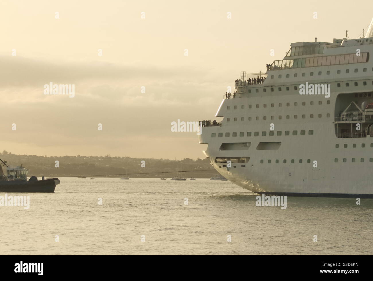 Tugboat Pulling A Large Cruise Ship Stock Photo Alamy