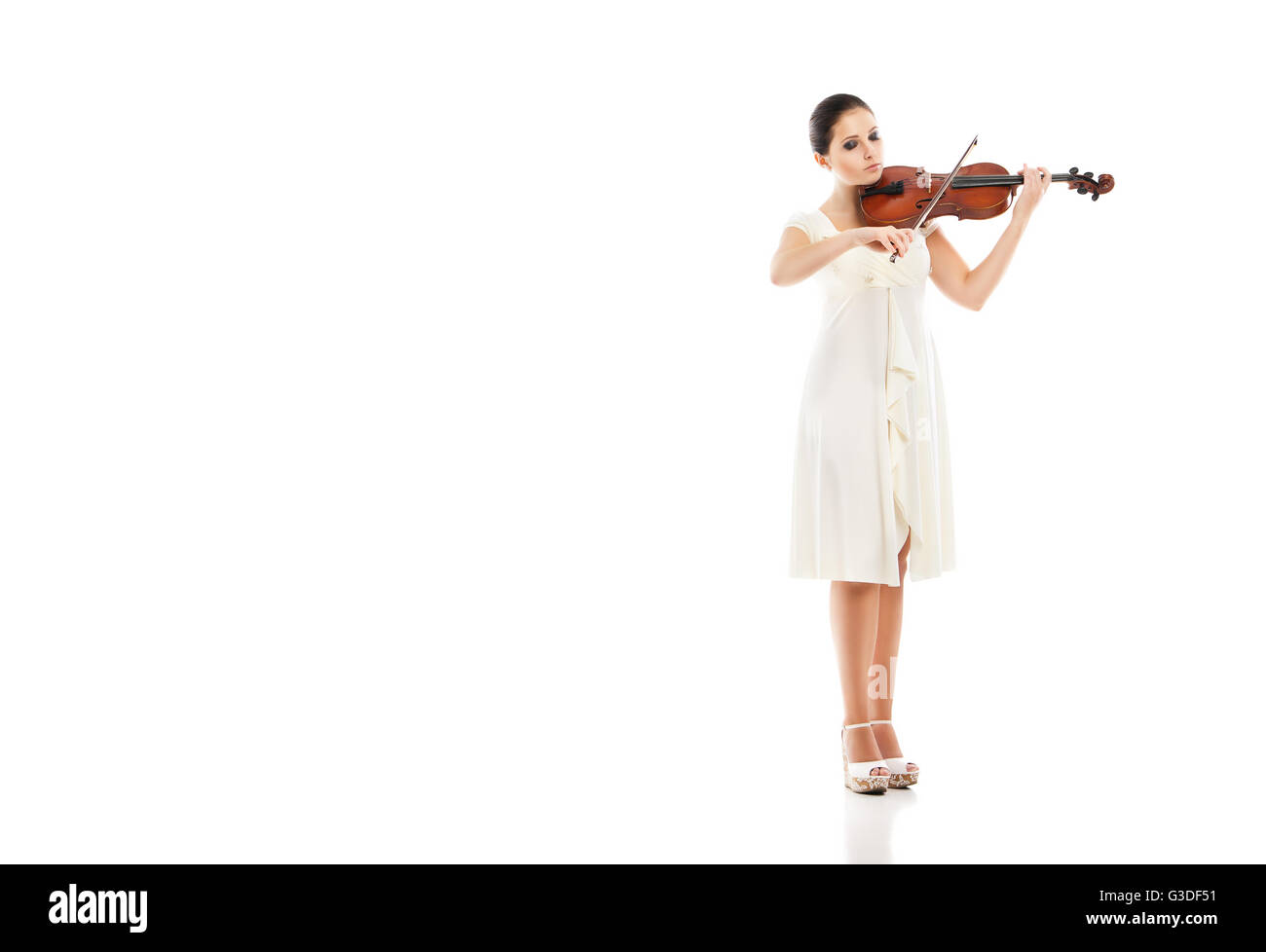 Beautiful young woman playing violin over white background Stock Photo ...