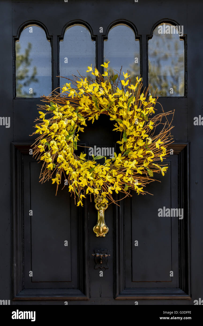 A springtime wreath made with twigs and forsythia spring flowers. Stock Photo