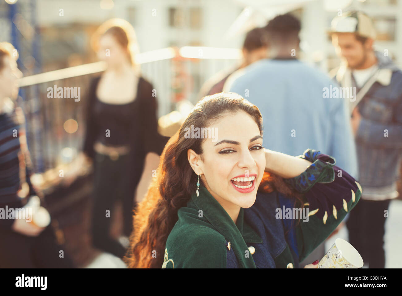 Portrait enthusiastic young woman enjoying rooftop party Stock Photo