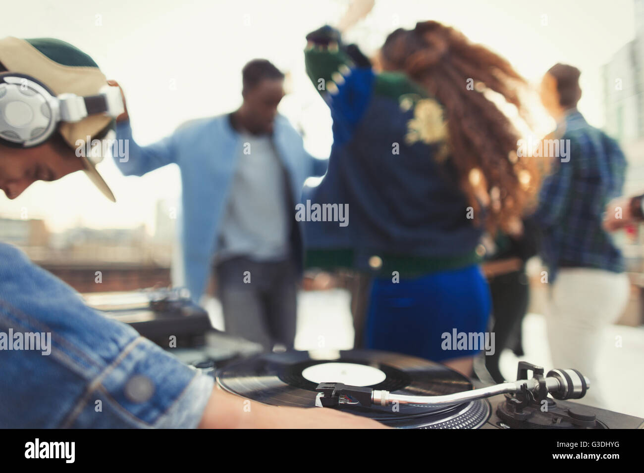 DJ spinning records at rooftop party Stock Photo