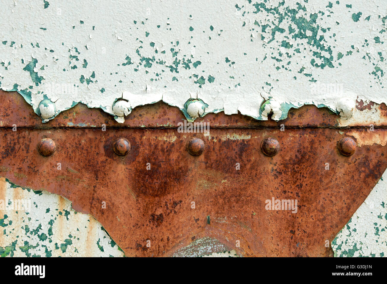 Peeling paint rust and rivets texture. Old metal garage door Stock Photo