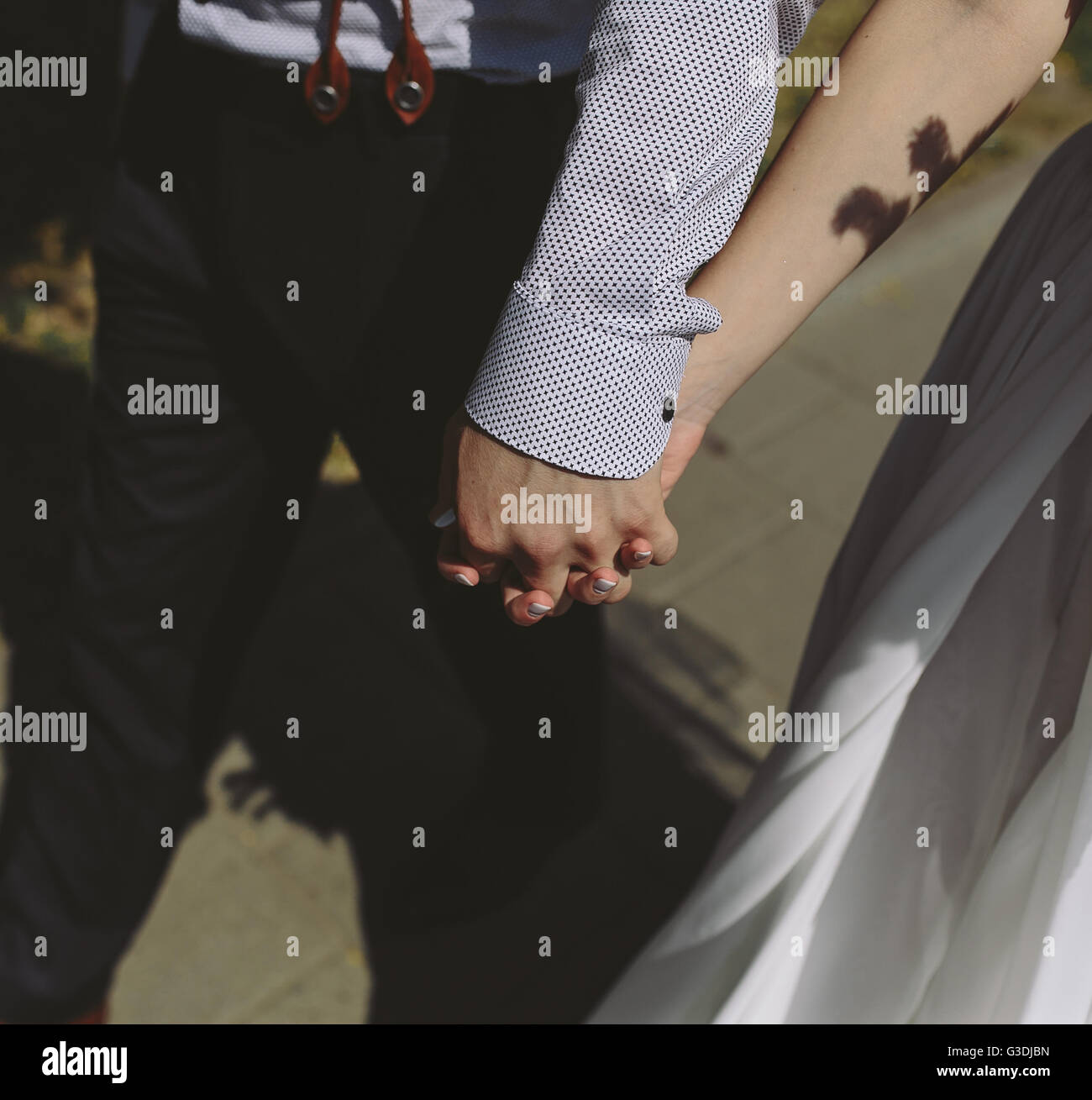 bride and groom walking around the city Stock Photo - Alamy