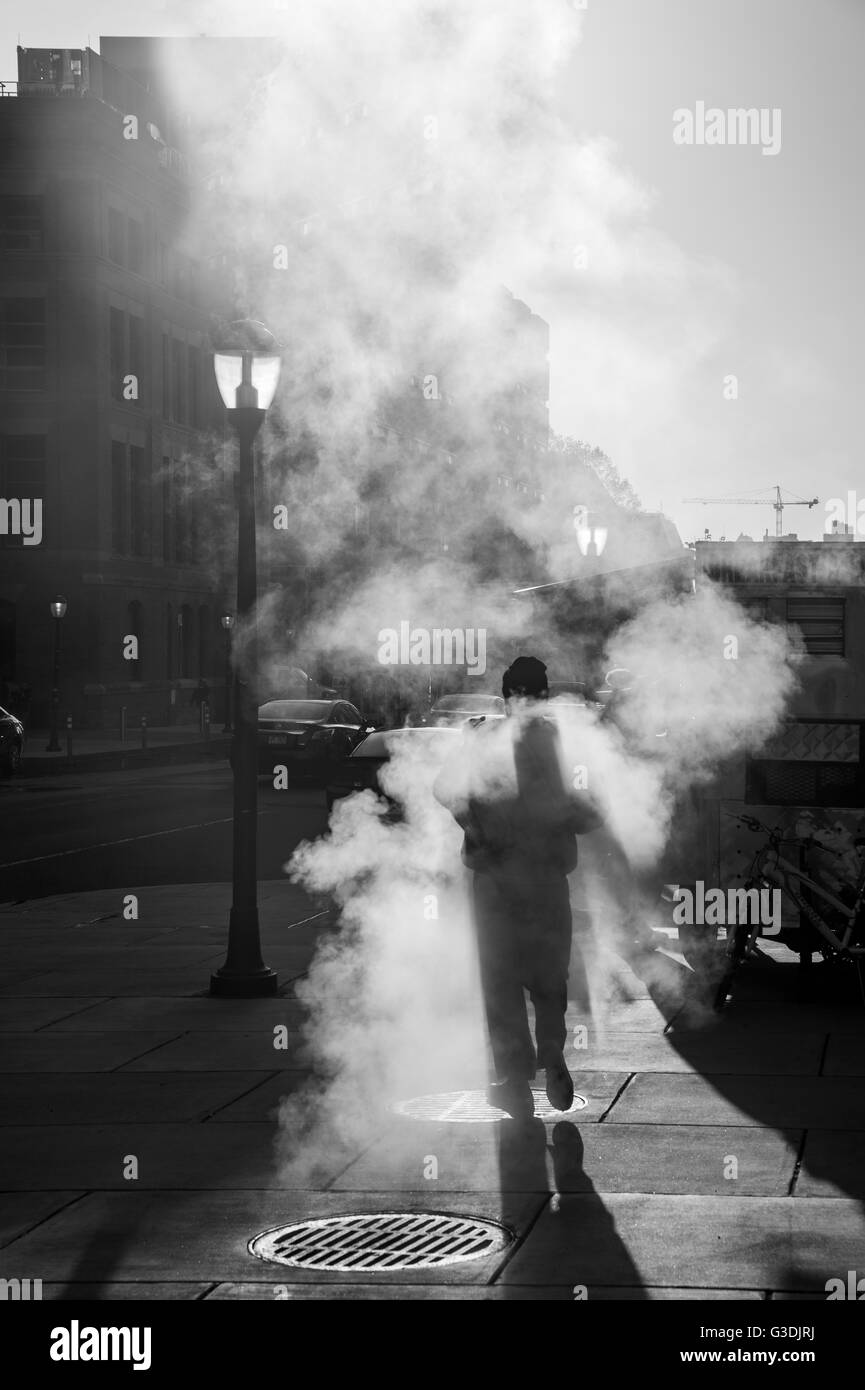 Pedestrian Walking Over Steam Vent, City Street Philadelphia USA Stock Photo