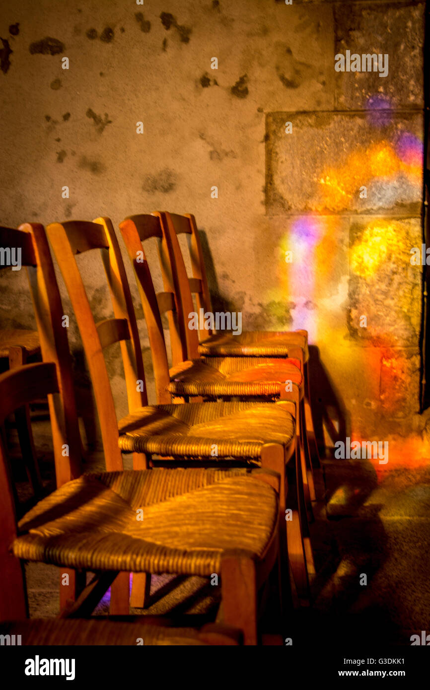 Wooden chairs in a church, Auvergne, France Stock Photo