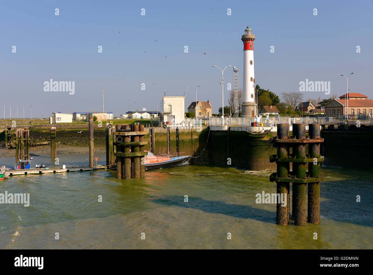 Port and lighthouse of Ouistreham at low tide in the Calvados department in the Basse-Normandie region in northwestern France. Stock Photo
