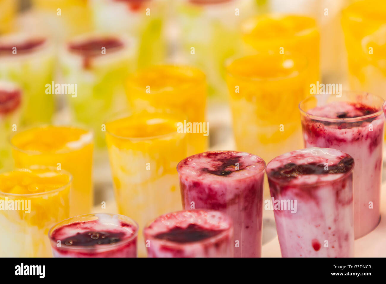 Frozen fruit smoothies with fresh blended different fruits served in